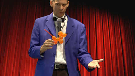 The magician performs a magic trick with a balloon animal during a virtual magic show!